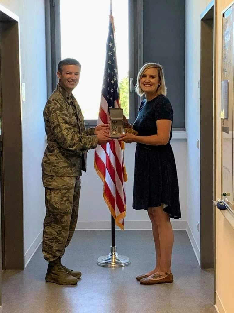 Kelley Beck receiving a military service medal recognizing her United States Air Force service